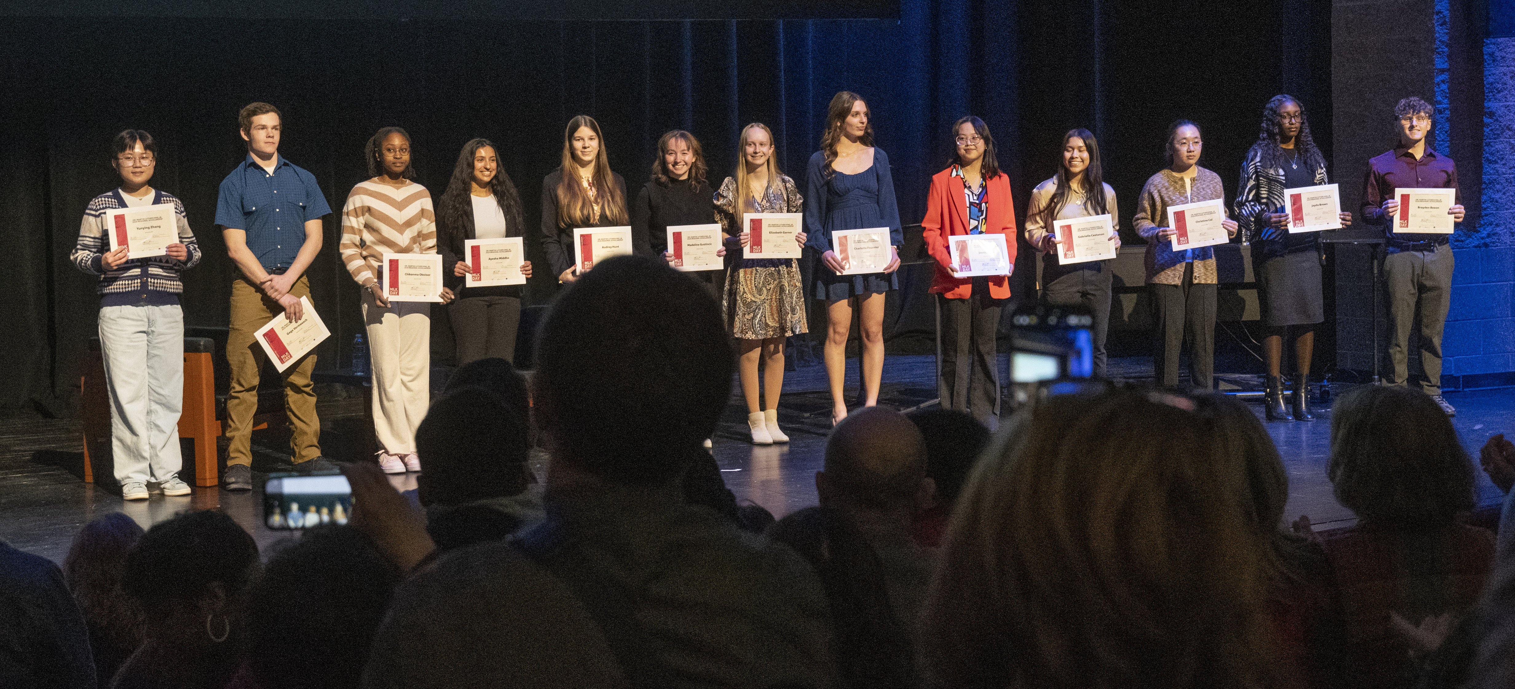 Scholarship Recipients onstage with scholarships